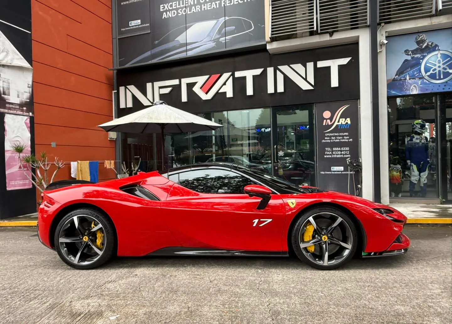 Ferrari SF90 tan leather interior seen through tinted glass at Infratint Singapore
