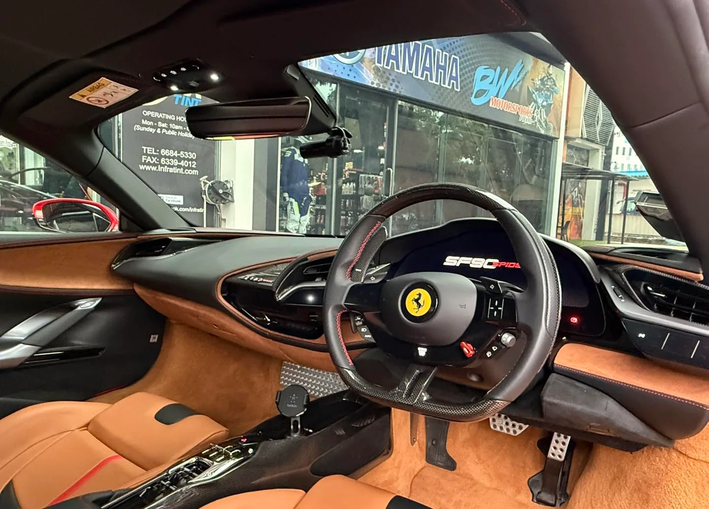 Red Ferrari SF90 rear three-quarter view outside Infratint Singapore