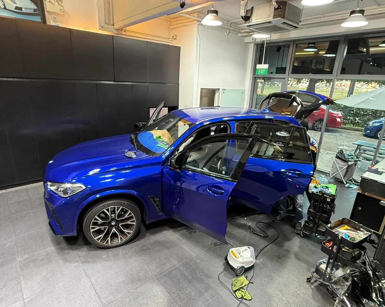 Blue BMW X5 M being tinted in the bay at Infratint Singapore