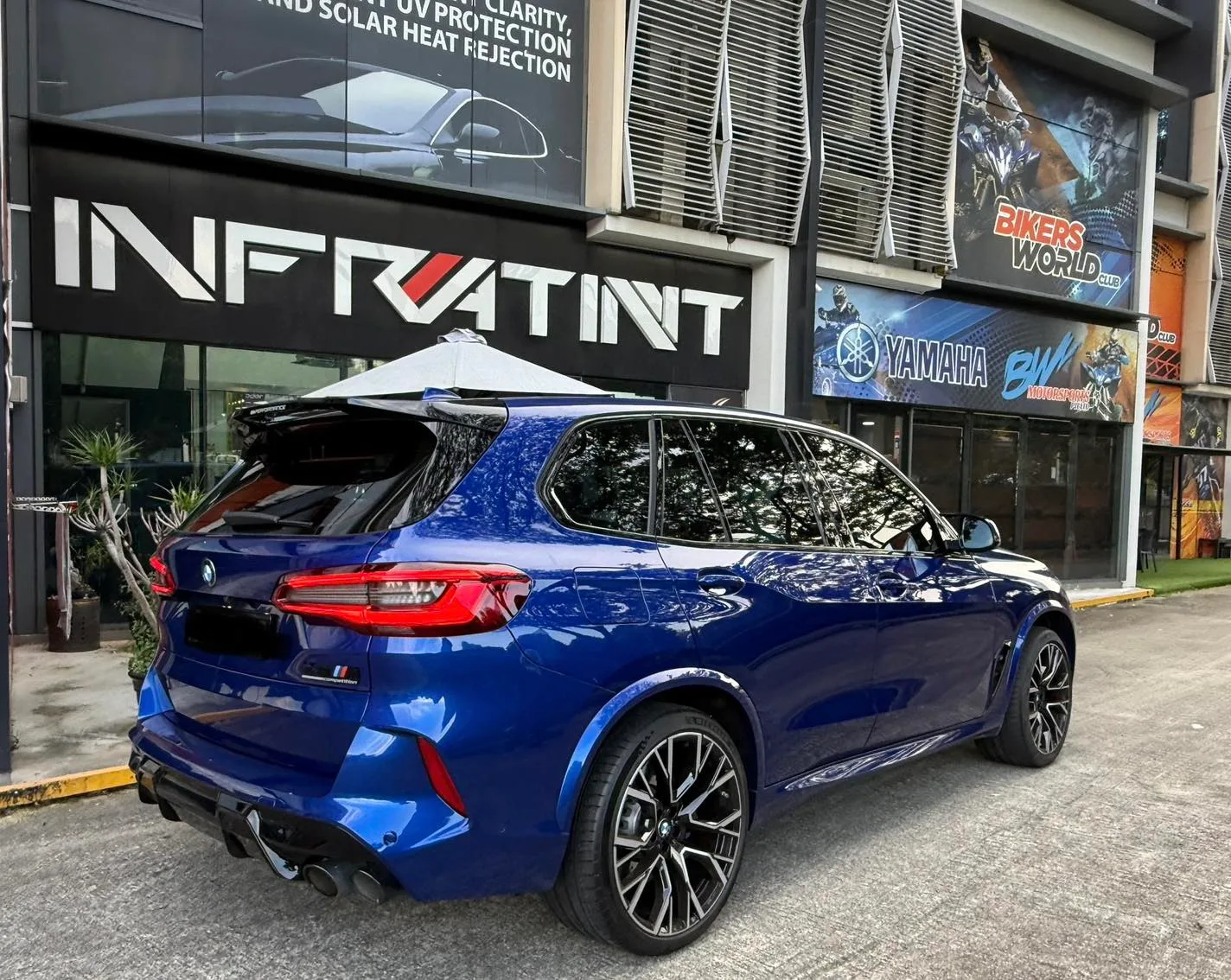 Blue BMW X5 M seen from the rear three-quarter at Infratint Singapore
