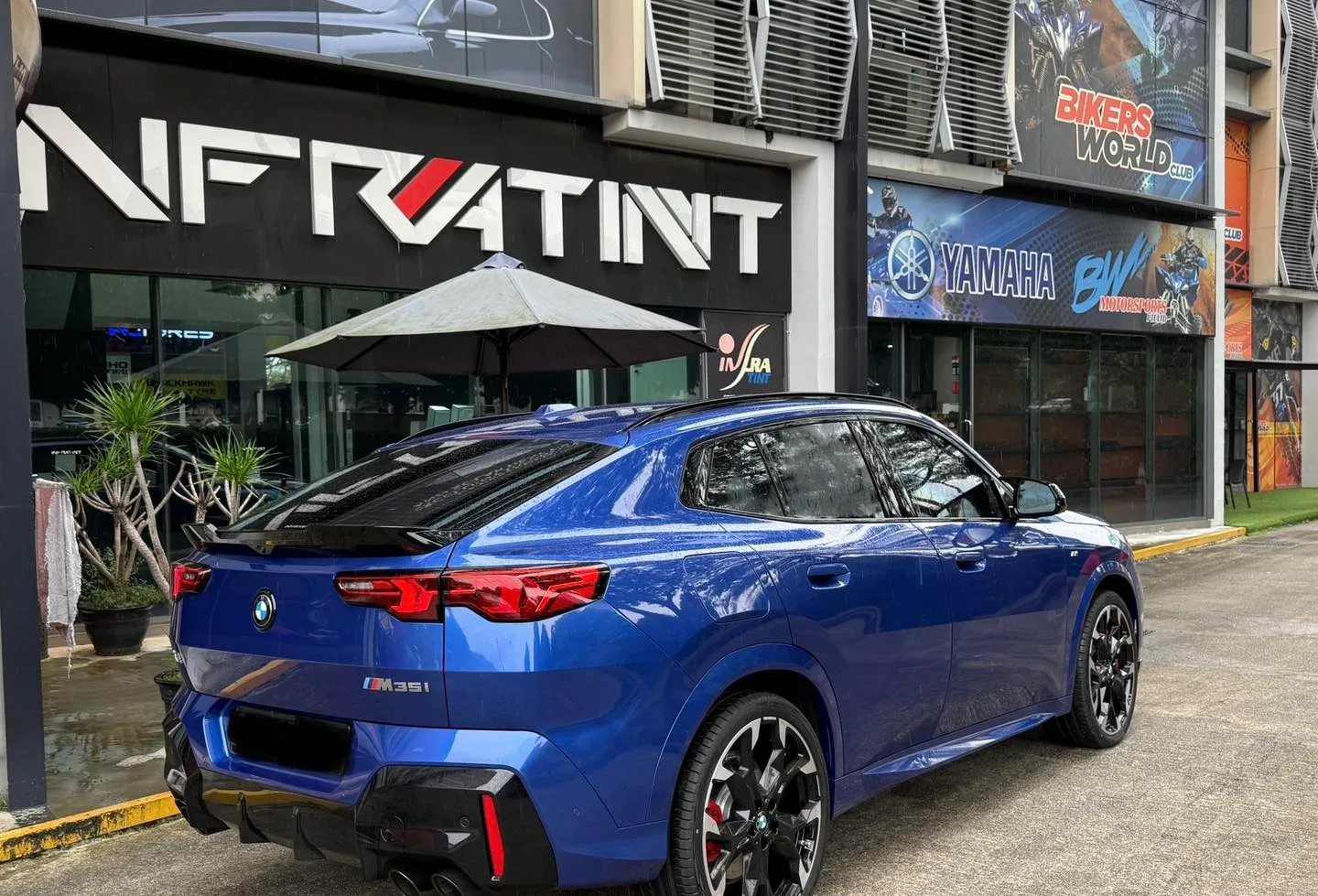 Blue BMW X2 M35i rear three-quarter view outside Infratint Singapore