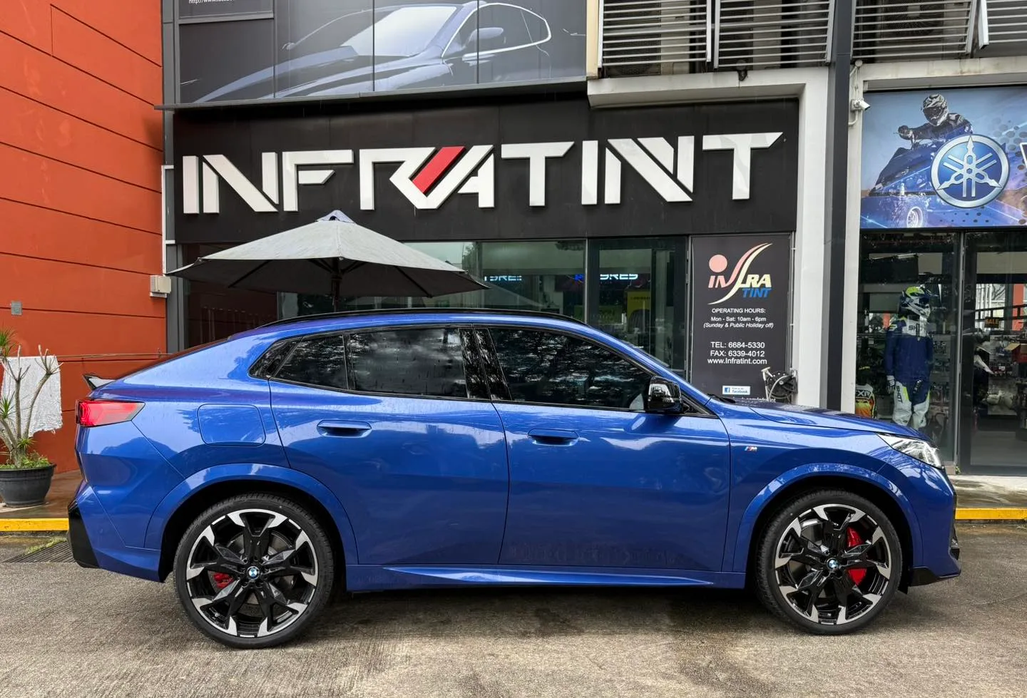 Blue BMW X2 side profile outside Infratint Singapore