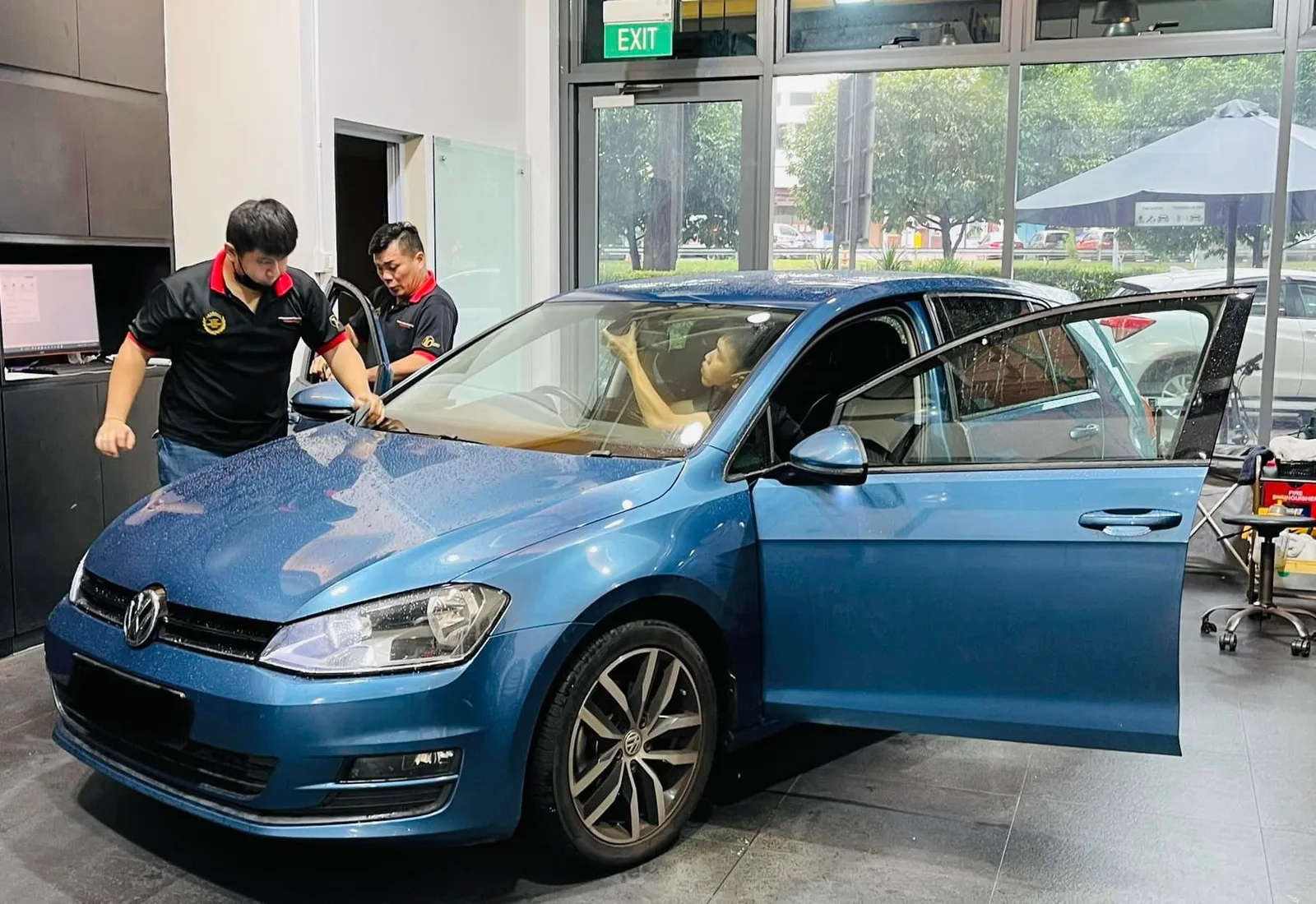 Blue Volkswagen Golf front three-quarter during window tinting at Infratint Singapore