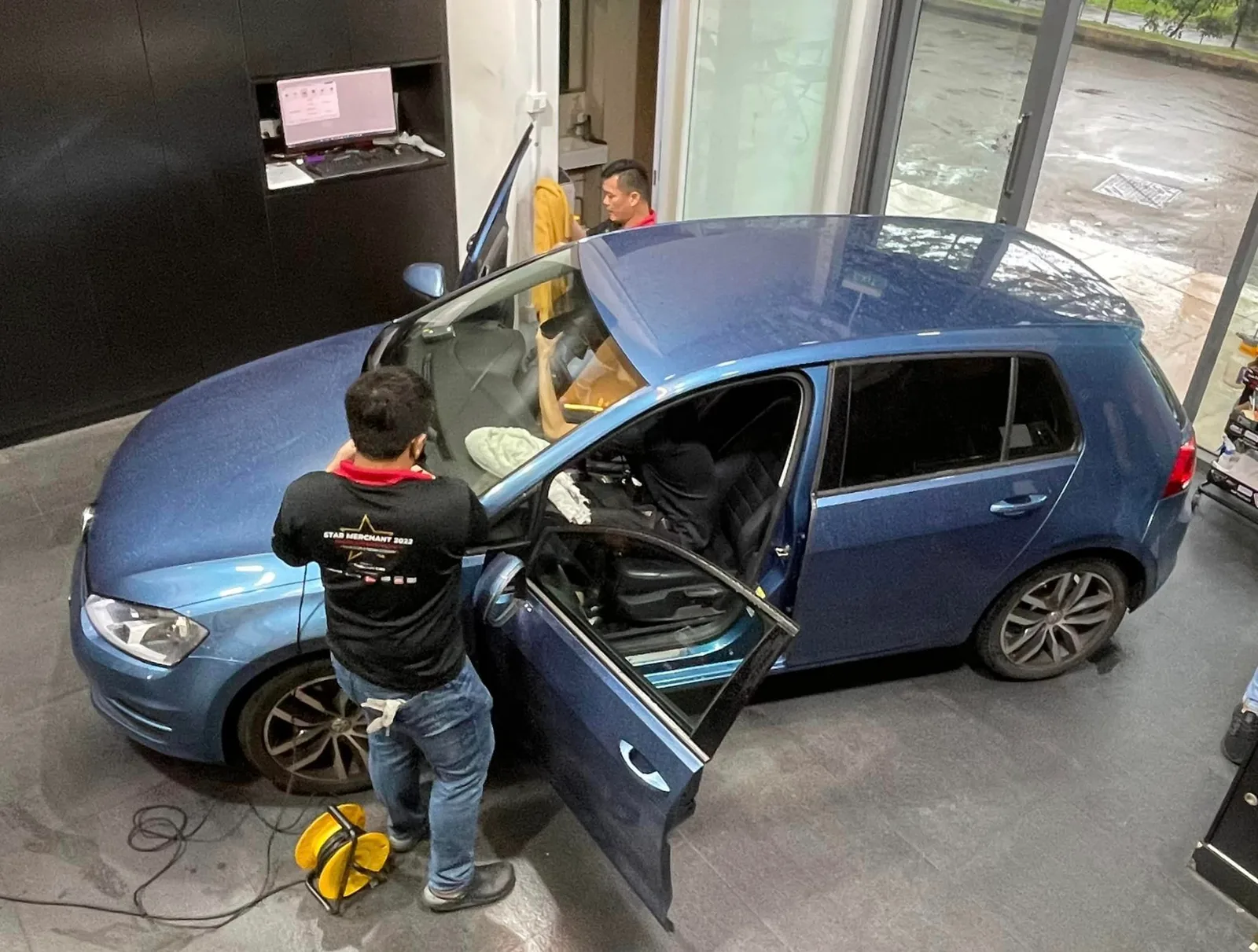 Overhead view of a blue Volkswagen Golf being tinted at Infratint Singapore