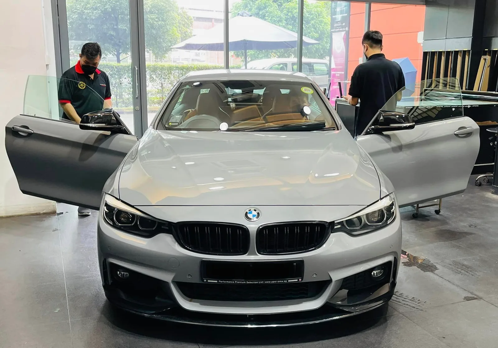 Grey BMW 4 Series coupe with doors open during window tinting at Infratint Singapore