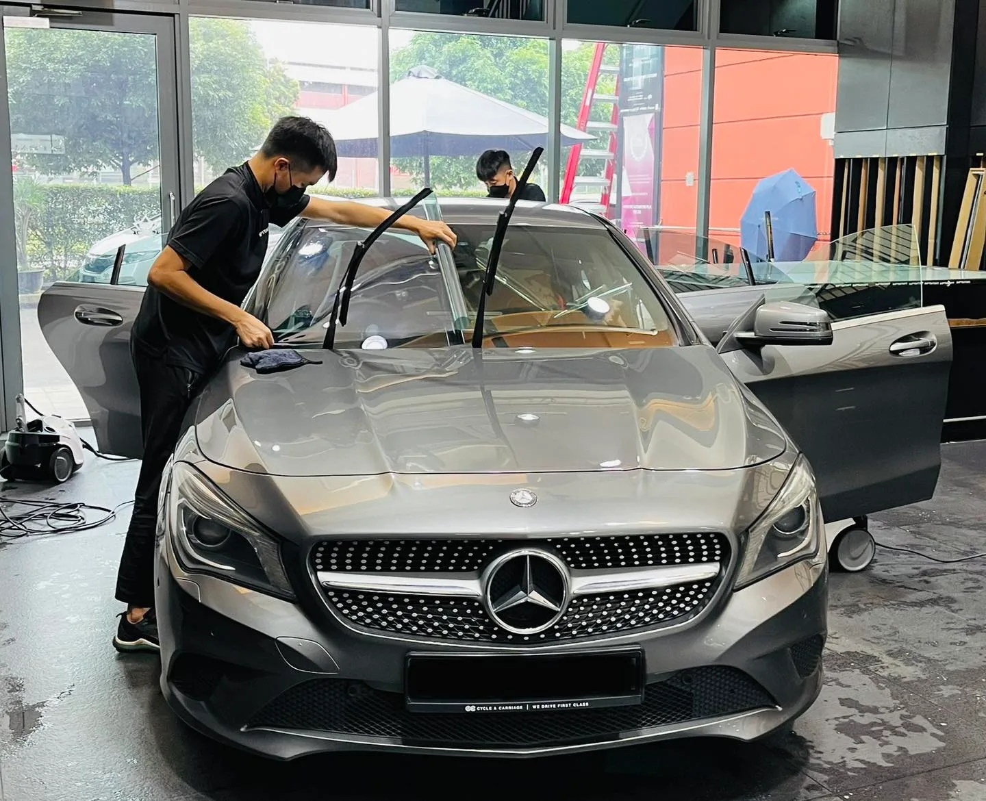 Installer prepping a grey Mercedes-Benz CLA windscreen at Infratint Singapore
