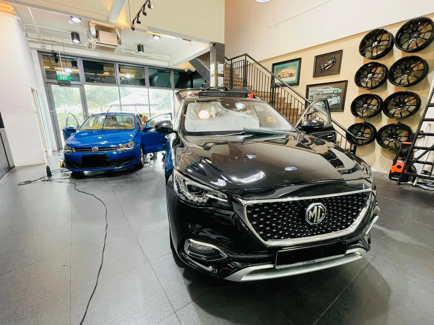 Black MG SUV front view beside a blue Volkswagen at Infratint Singapore