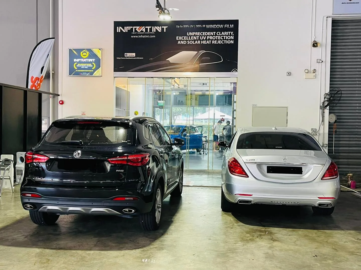 Black SUV and silver Mercedes-Benz sedan in the install bay at Infratint Singapore