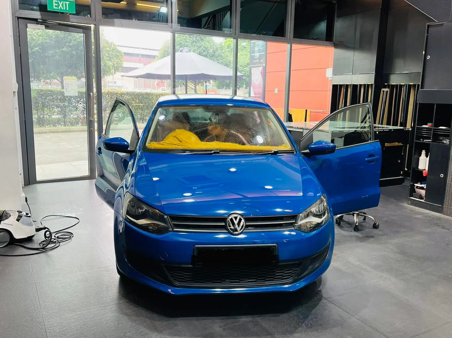 Blue Volkswagen hatchback front view with doors open at Infratint Singapore