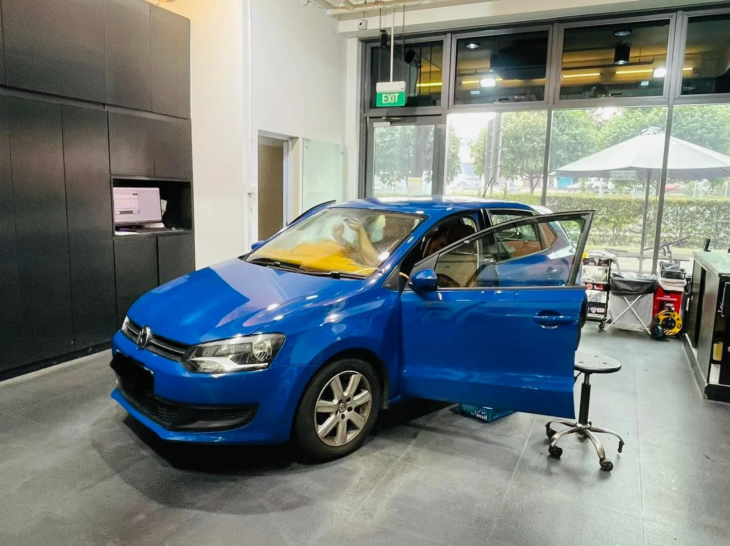 Blue Volkswagen hatchback side profile during tinting at Infratint Singapore