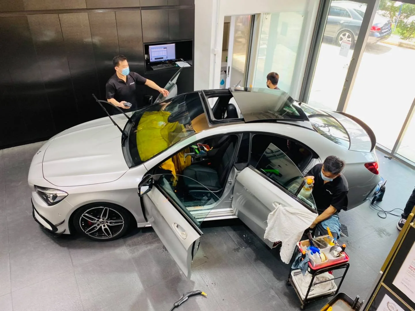 Overhead view of a silver Mercedes-Benz CLA being tinted at Infratint Singapore