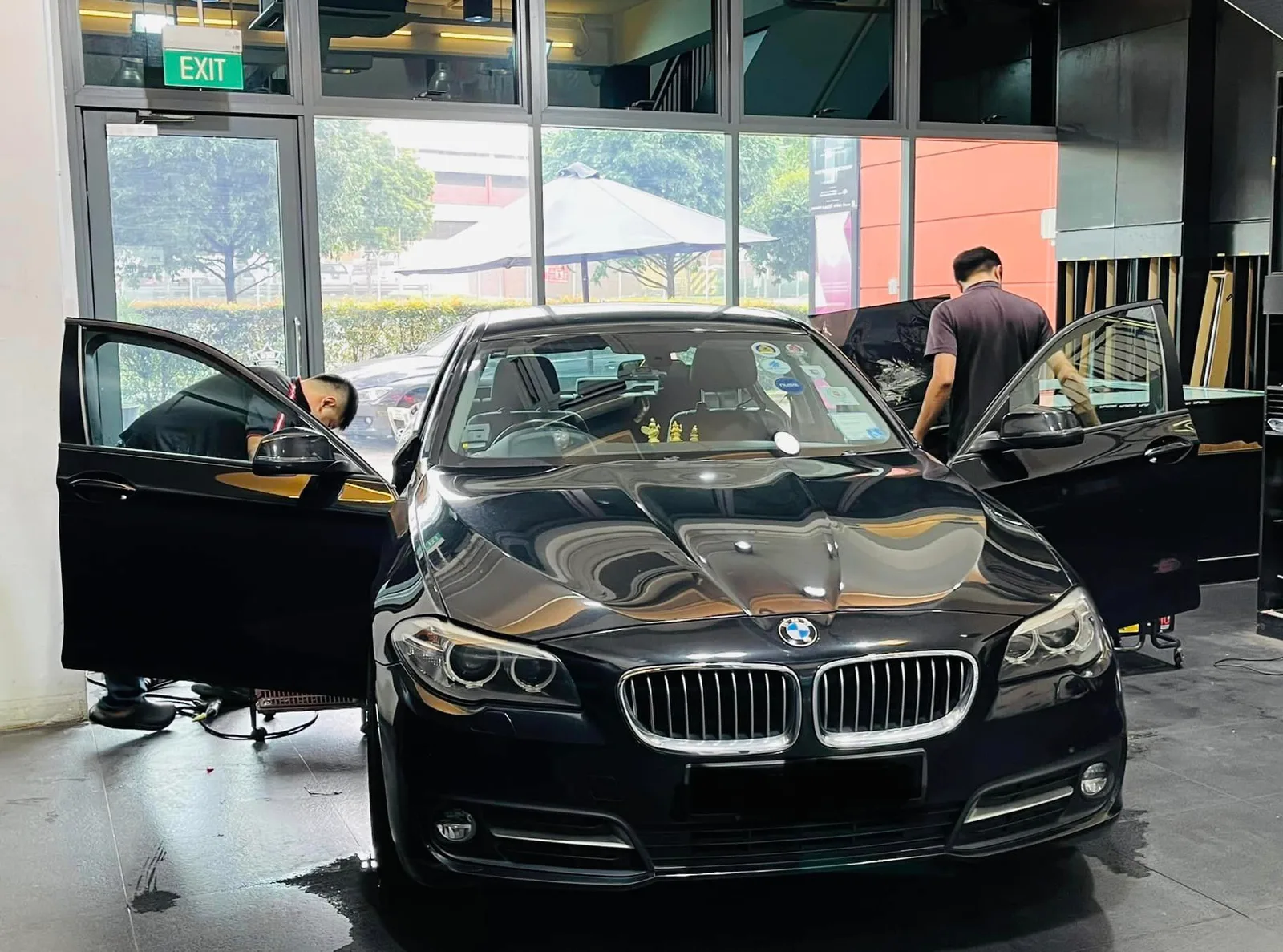 Black BMW 5 Series having its windows tinted at Infratint Singapore
