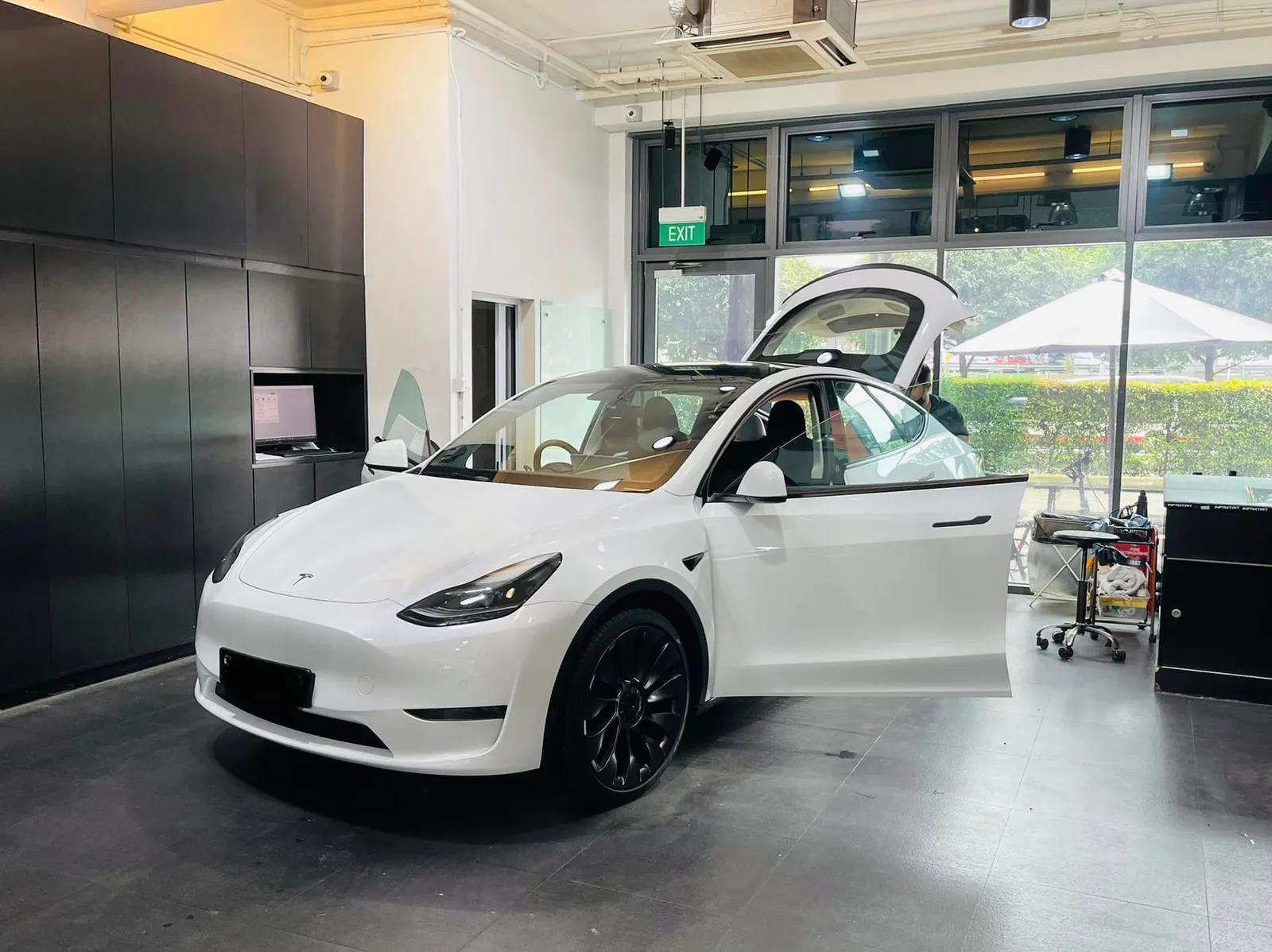 White Tesla Model Y in front three-quarter view at Infratint Singapore for tinting