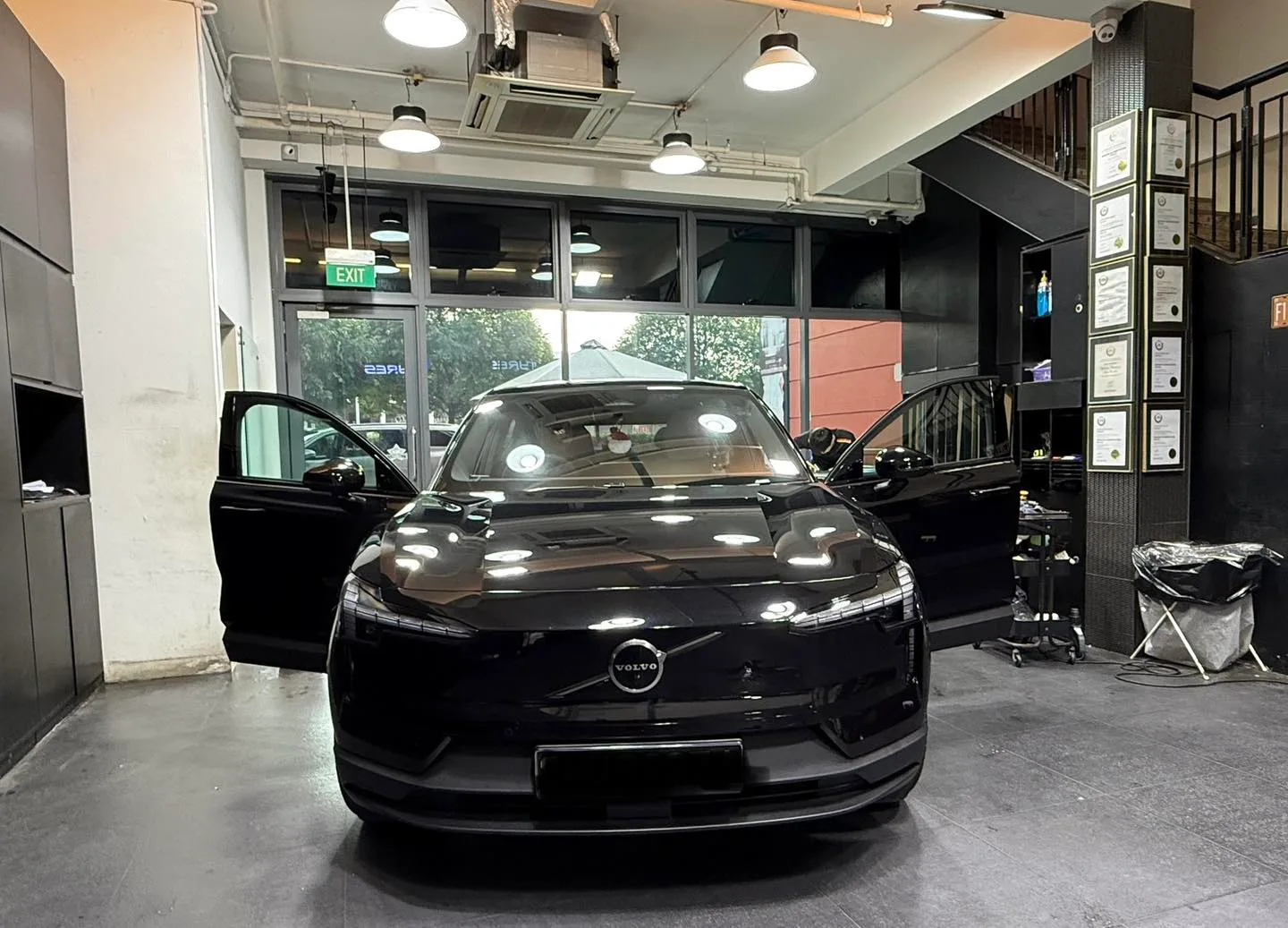 Volvo EX30 inside the Infratint installation bay with a door open