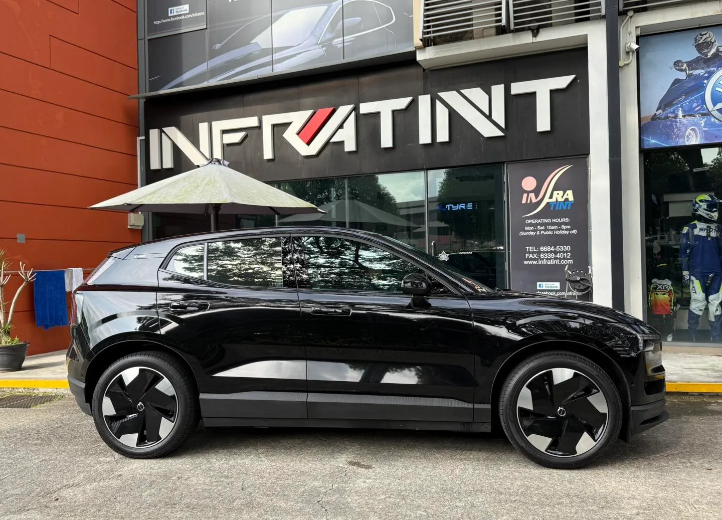 Tinted black Volvo EX30 side profile outside Infratint Singapore