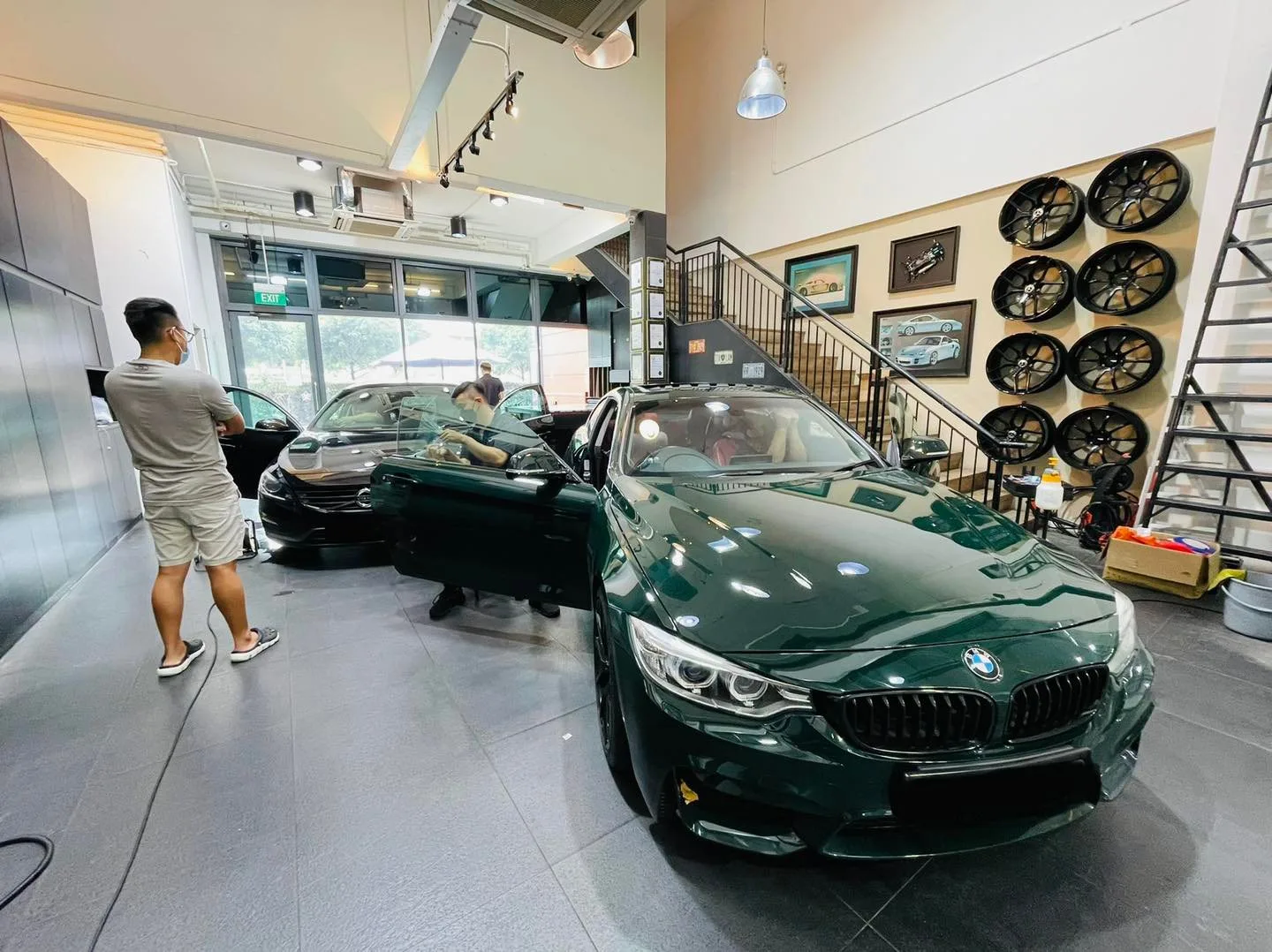 Dark green BMW coupe inside the Infratint Singapore showroom for window tinting
