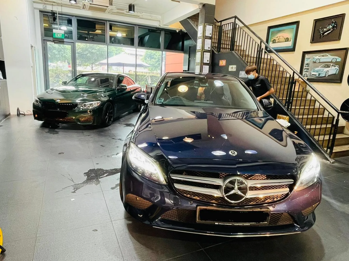 Navy Mercedes-Benz sedan and green BMW coupe inside the Infratint Singapore showroom