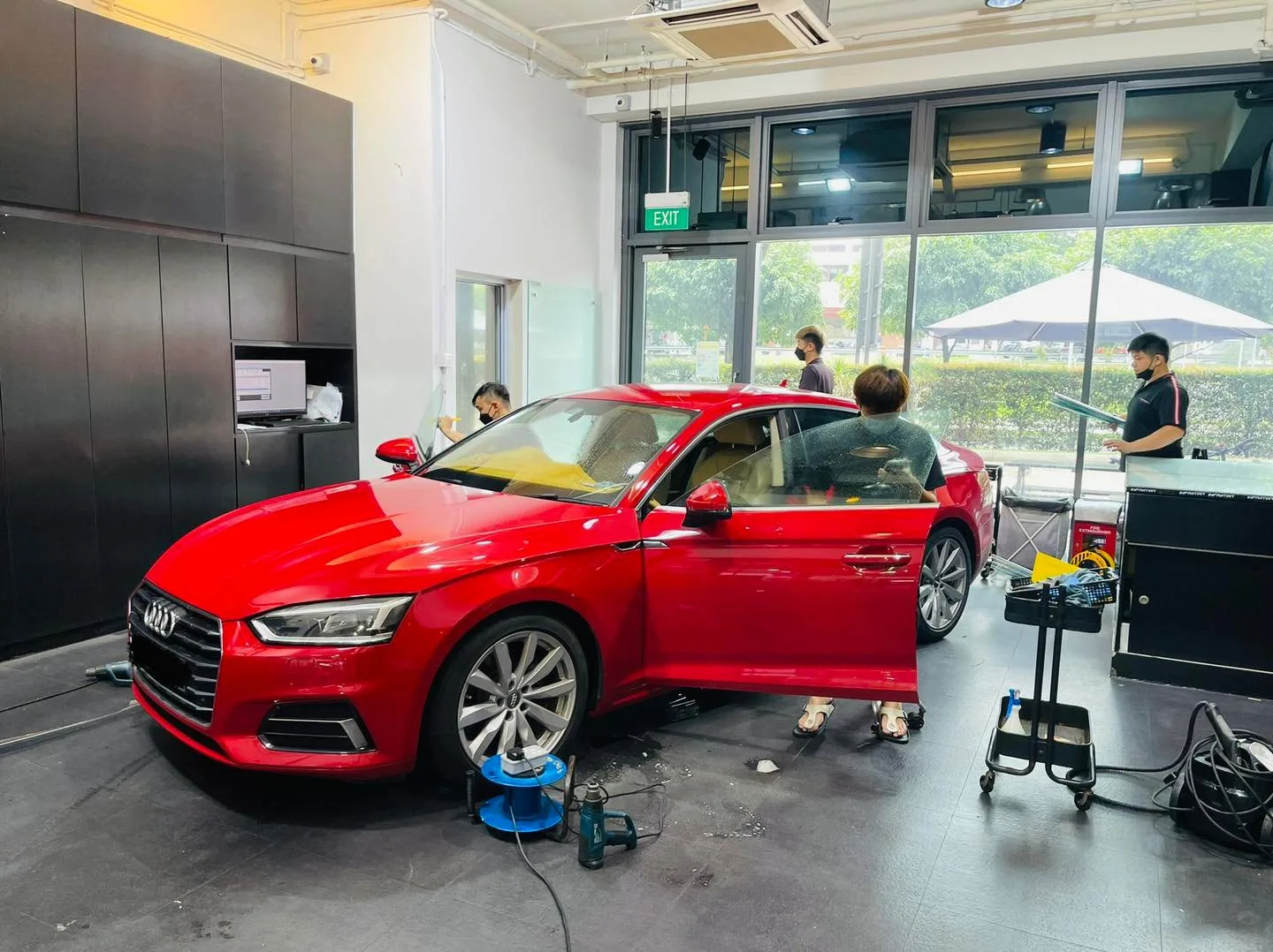 Red Audi with door open during window tinting at Infratint Singapore