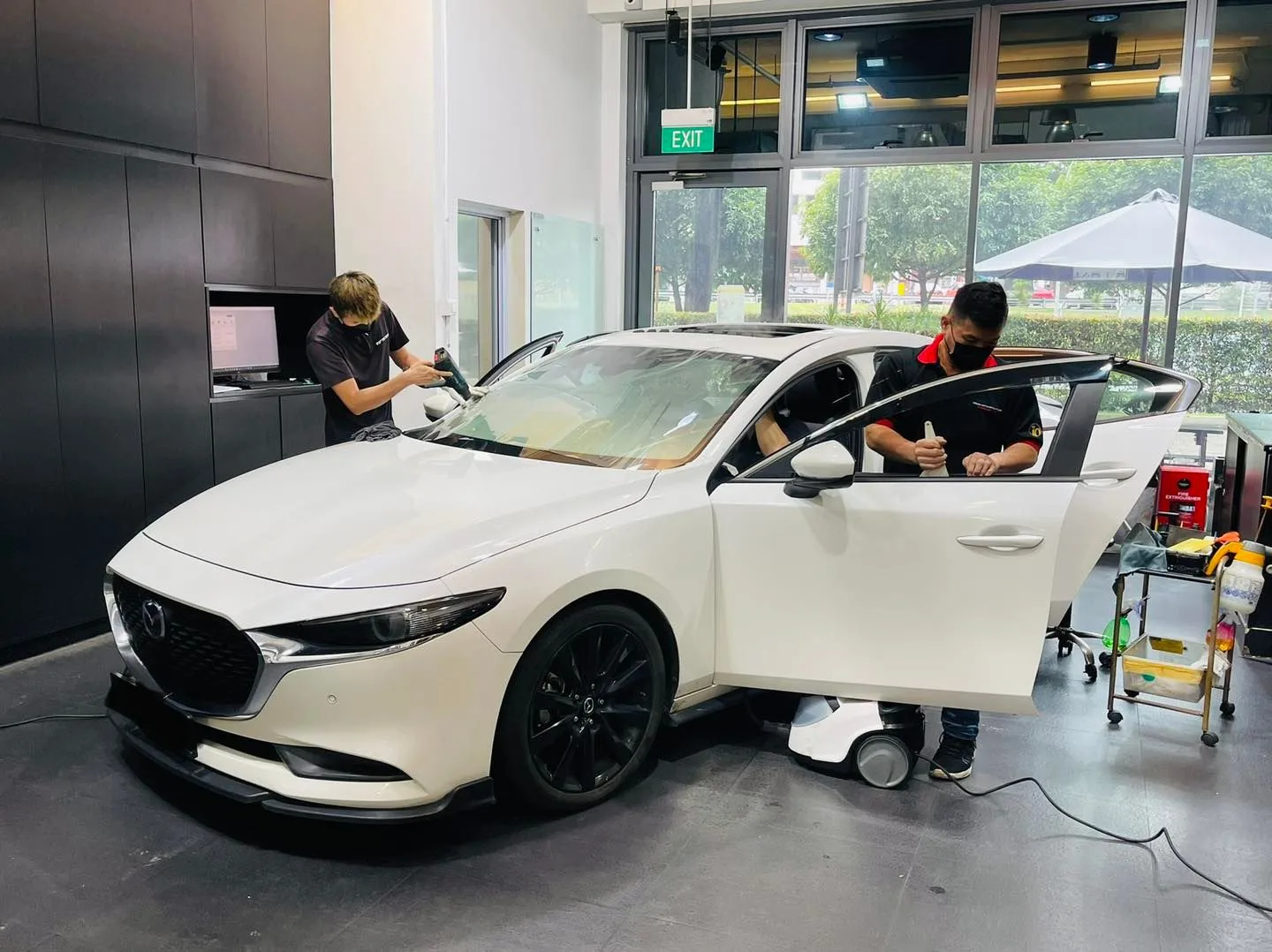 White Mazda 3 sedan having window film applied at Infratint Singapore