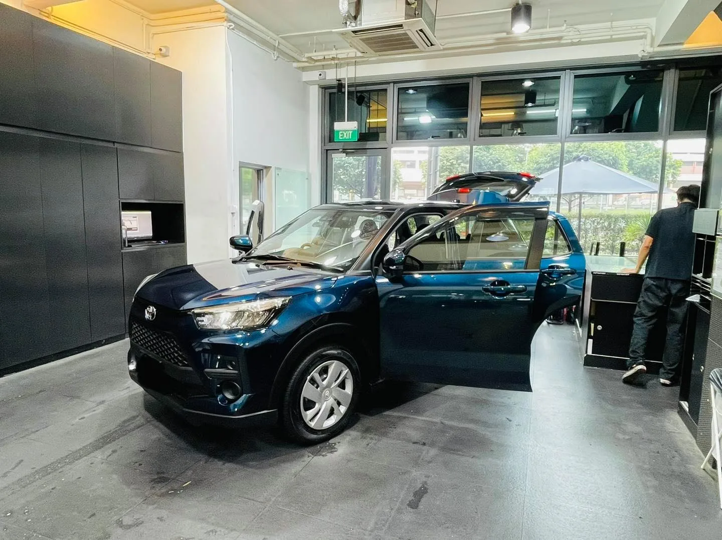 Dark blue Toyota Raize side view during tinting at Infratint Singapore