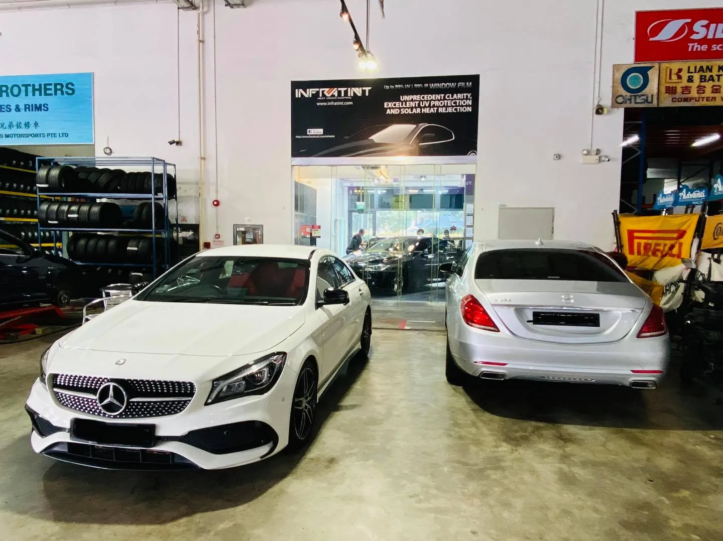 White Mercedes-Benz CLA and silver Mercedes-Benz S-Class at Infratint Singapore for window tinting