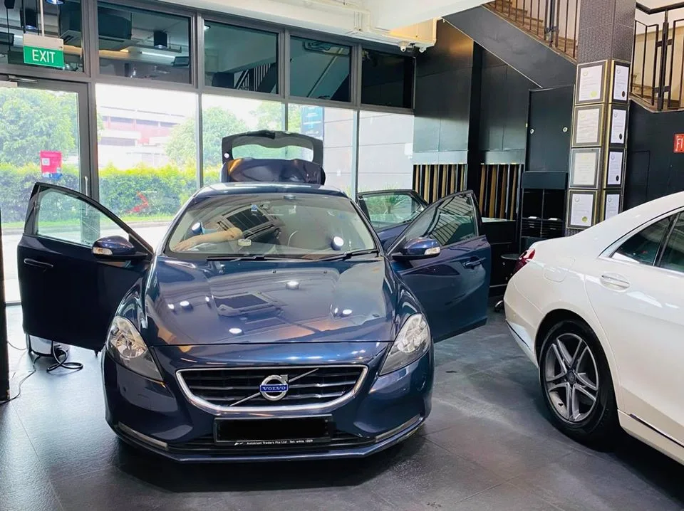 Dark blue Volvo V40 with doors open beside a white Mercedes-Benz at Infratint Singapore