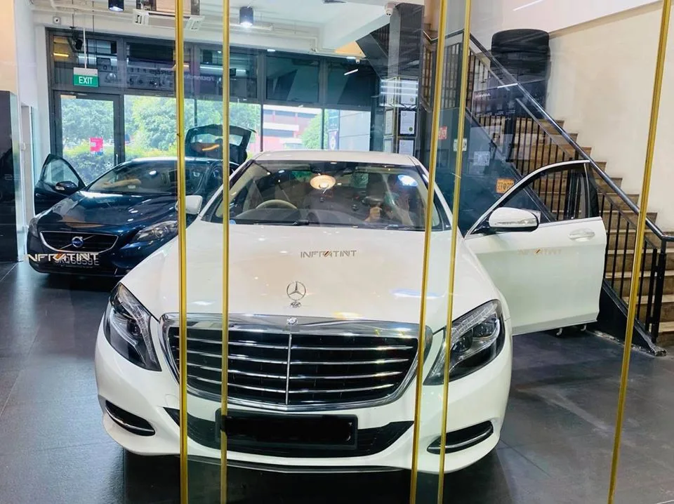 White Mercedes-Benz S-Class and dark blue Volvo inside the bay at Infratint Singapore