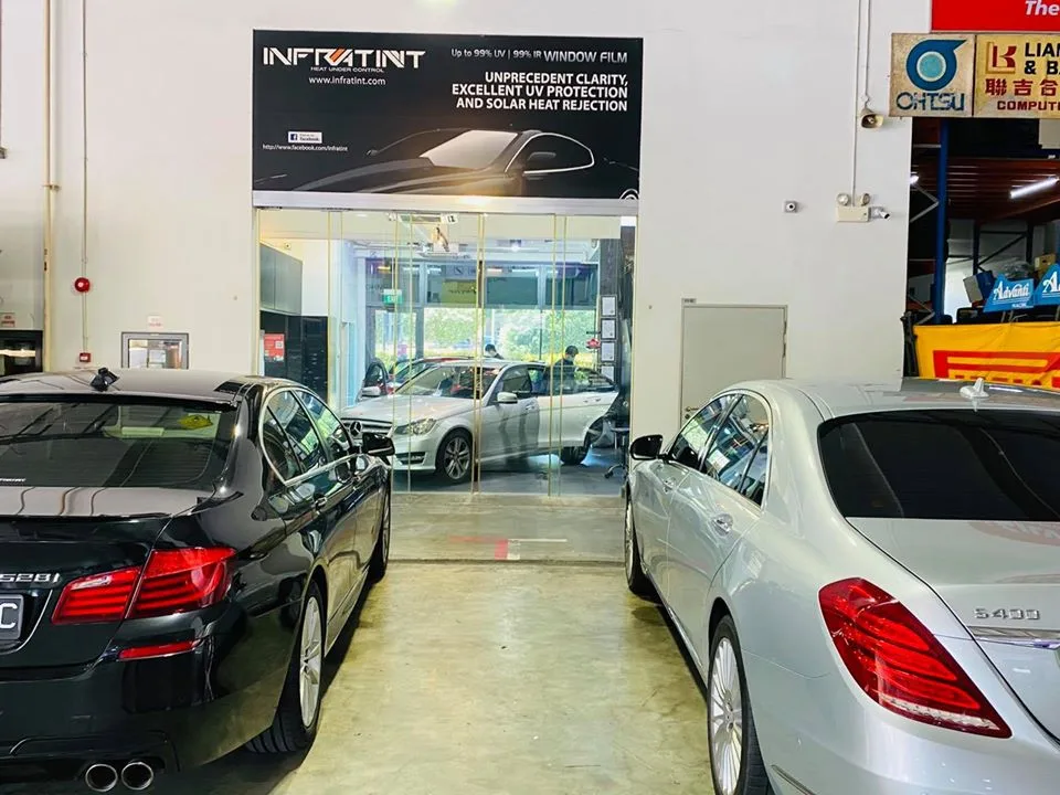 Black BMW 5 Series and silver Mercedes-Benz S-Class in the Infratint Singapore bay