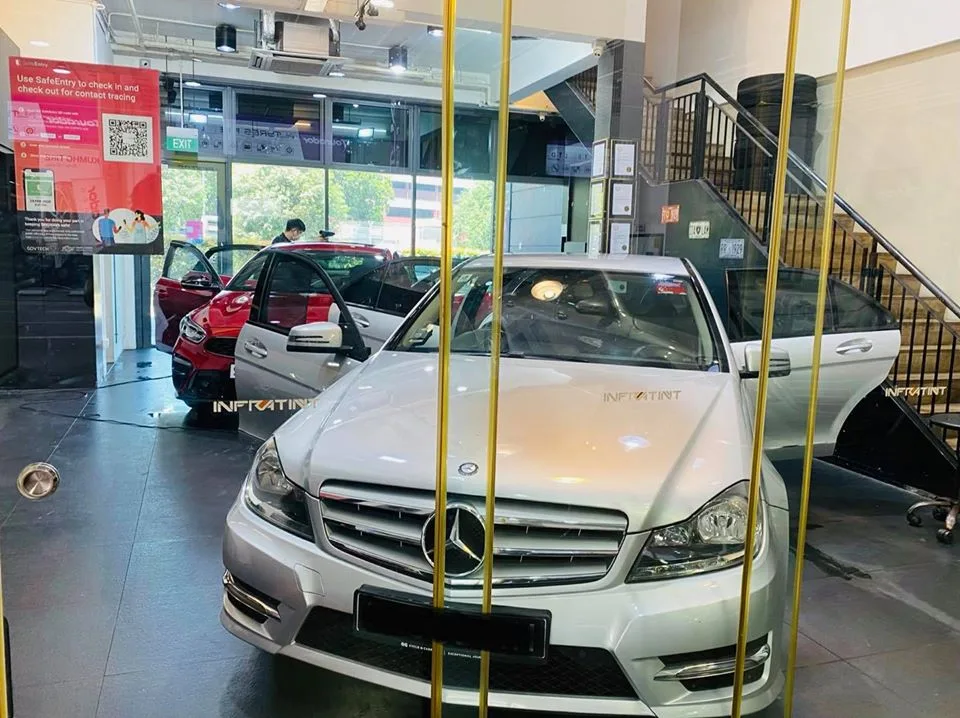 Silver Mercedes-Benz C-Class with doors open and Infratint sunshades during tinting
