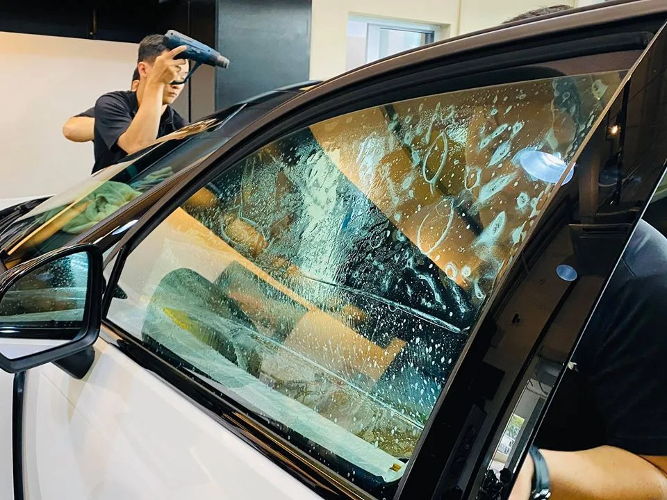 Wet freshly tinted door window of a Volvo XC40 at Infratint Singapore