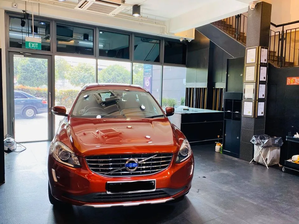 Copper-orange Volvo XC60 parked in the Infratint Singapore install bay