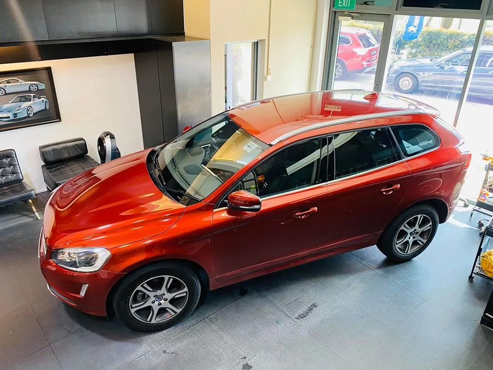 Copper-orange Volvo XC60 full side profile with tinted windows at Infratint Singapore