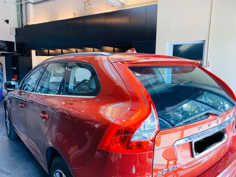 Copper-orange Volvo XC60 rear three-quarter with tinted windows at Infratint Singapore