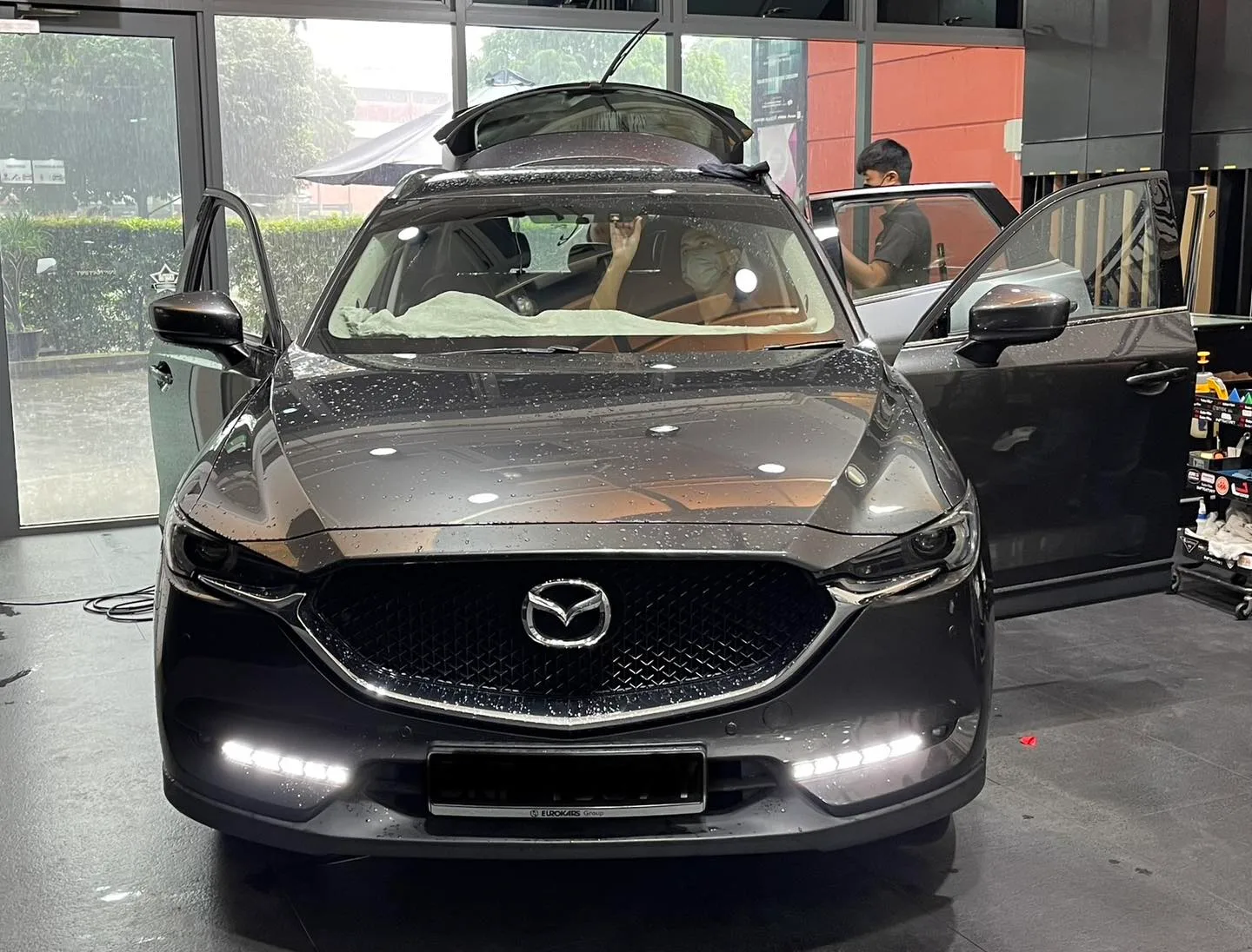 Grey Mazda CX-5 during window film install at Infratint Singapore