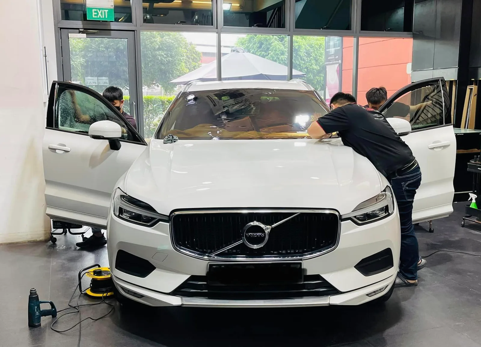 White Volvo XC60 during window film install at Infratint Singapore
