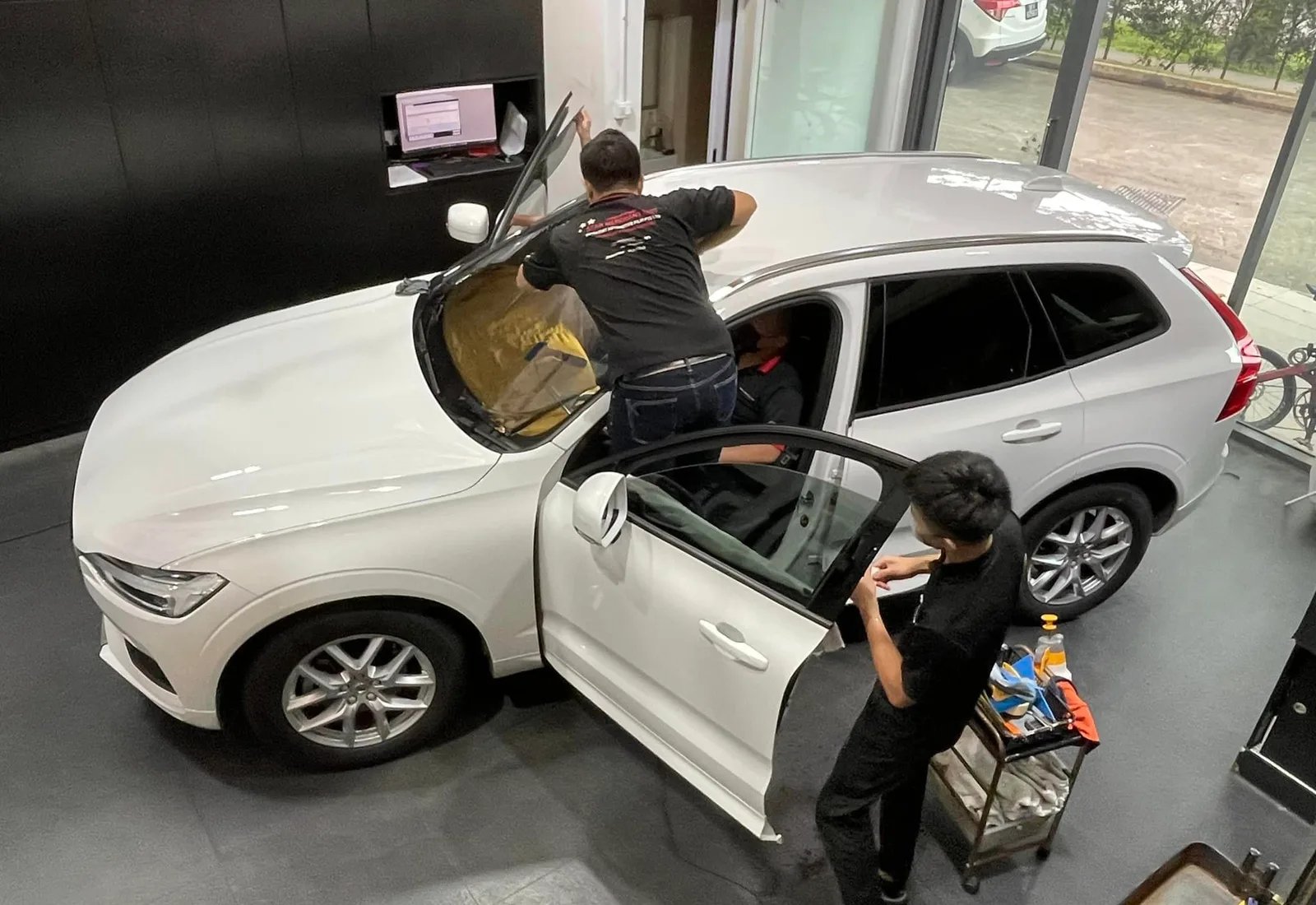 Overhead view of a white Volvo XC60 being tinted at Infratint Singapore
