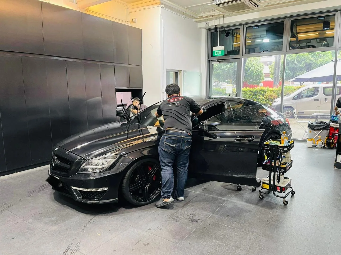 Black Mercedes-Benz CLS with red calipers being tinted at Infratint Singapore