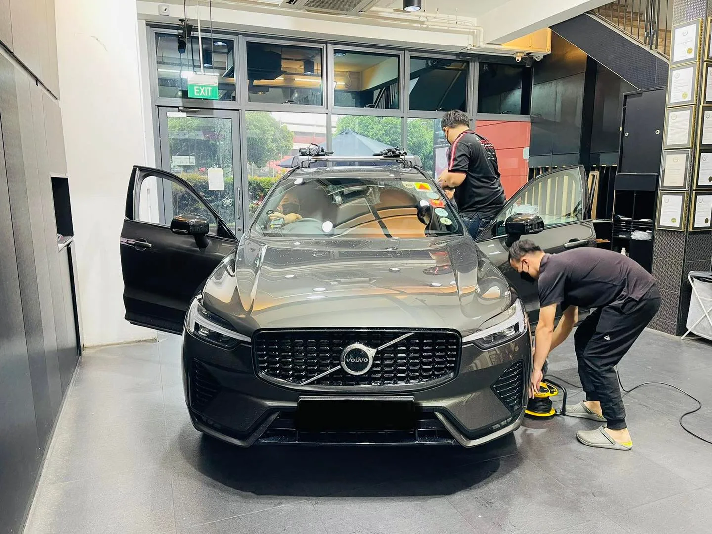 Technicians tinting a bronze Volvo XC60 windscreen at Infratint Singapore