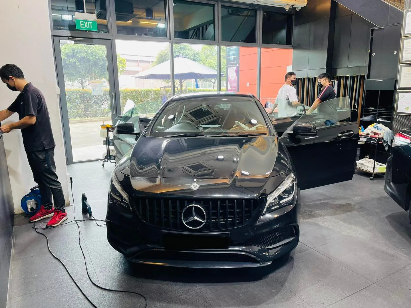 Black Mercedes-Benz CLA being prepared for window tinting at Infratint Singapore
