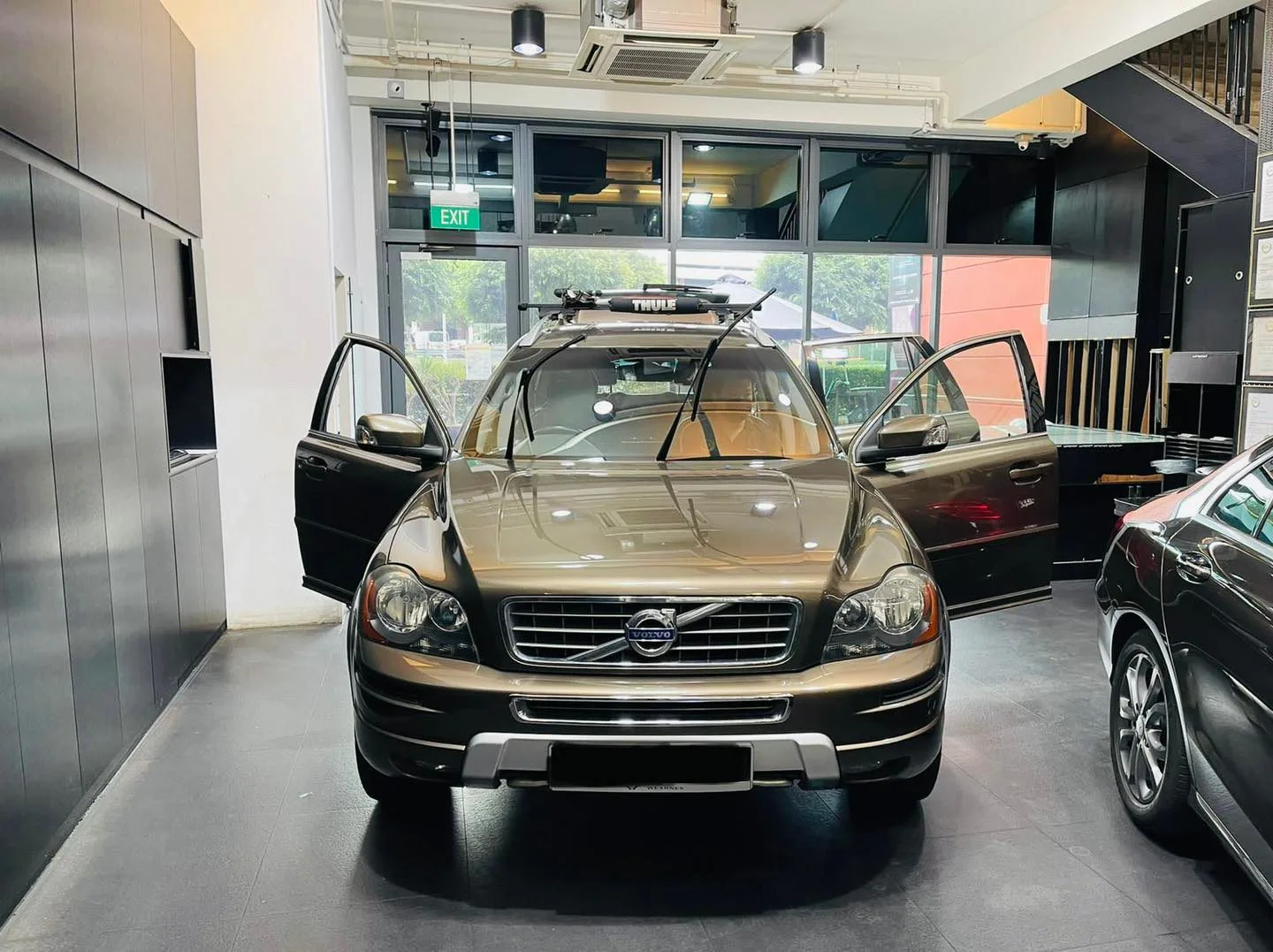 Bronze Volvo XC90 with doors open at Infratint Singapore window tinting bay