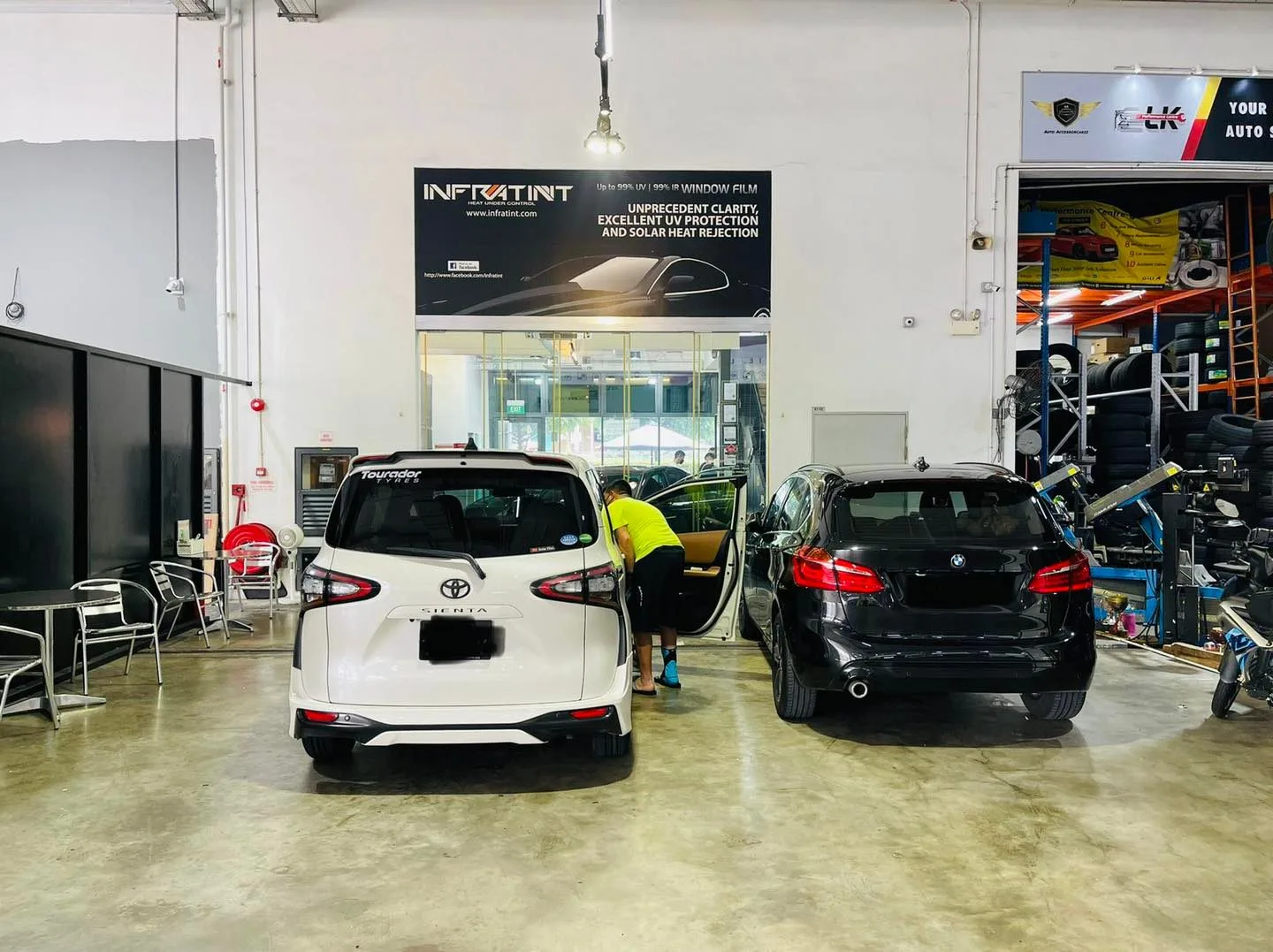White Toyota SUV and black BMW estate at Infratint Singapore for window film