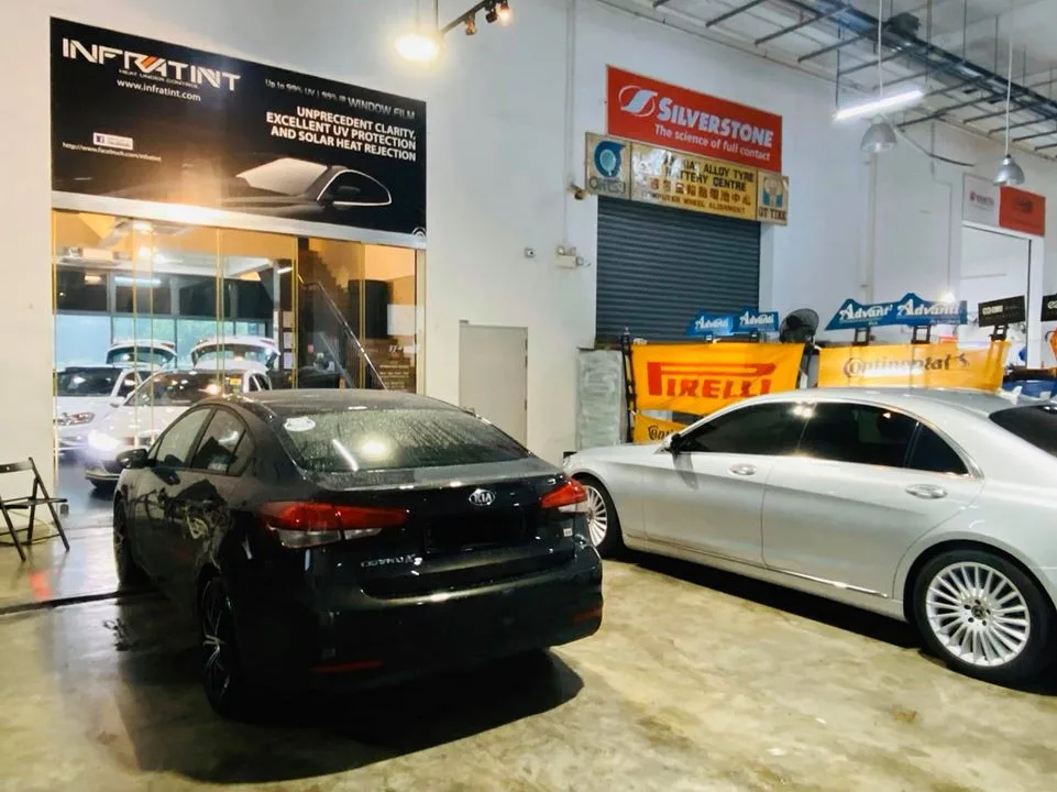 Black Kia Forte and silver Mercedes-Benz S-Class at Infratint Singapore for window film