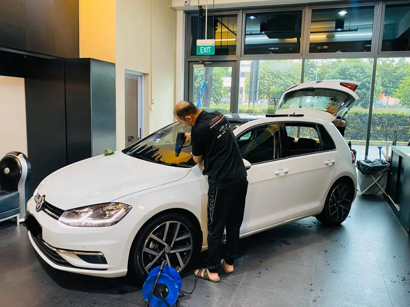 White Volkswagen Golf being tinted from the side at Infratint Singapore