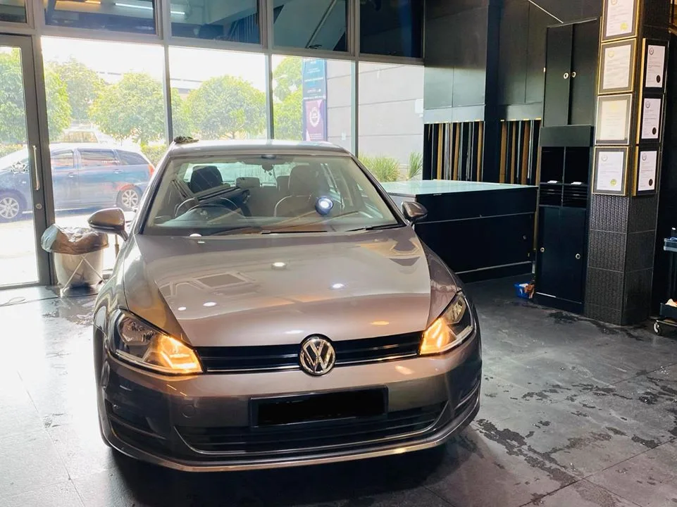 Grey Volkswagen Golf front view during window tinting at Infratint Singapore