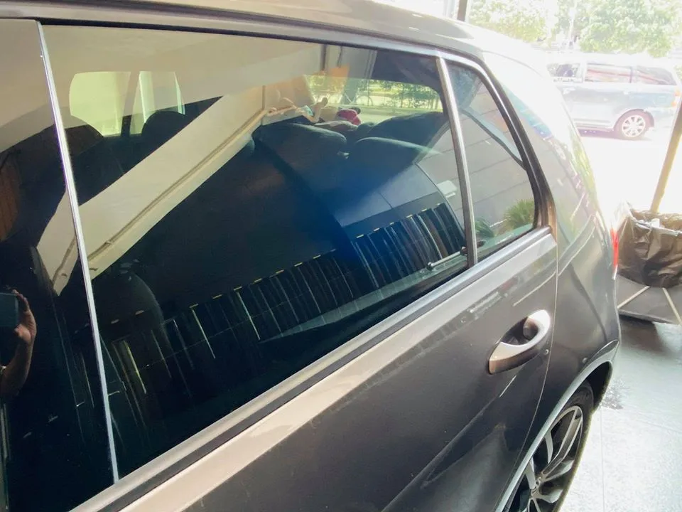 Close-up of the tinted rear door window on a grey Volkswagen Golf at Infratint Singapore