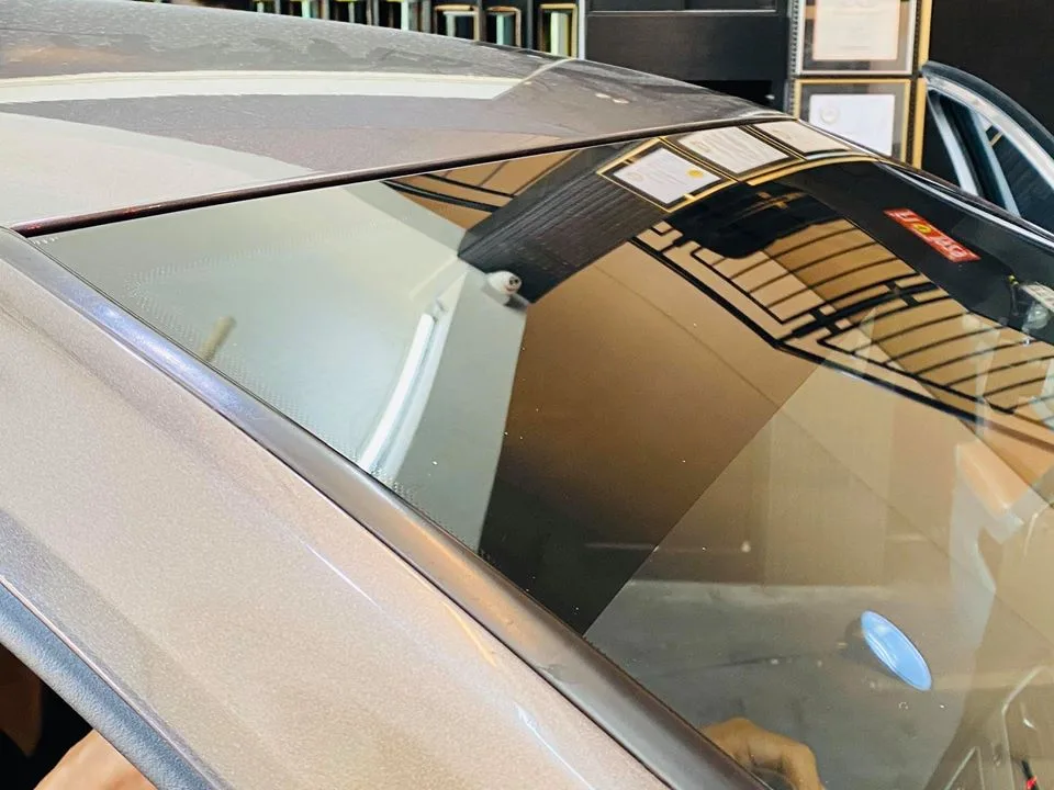 Detail of window film along the windscreen corner of a Volkswagen Golf at Infratint Singapore