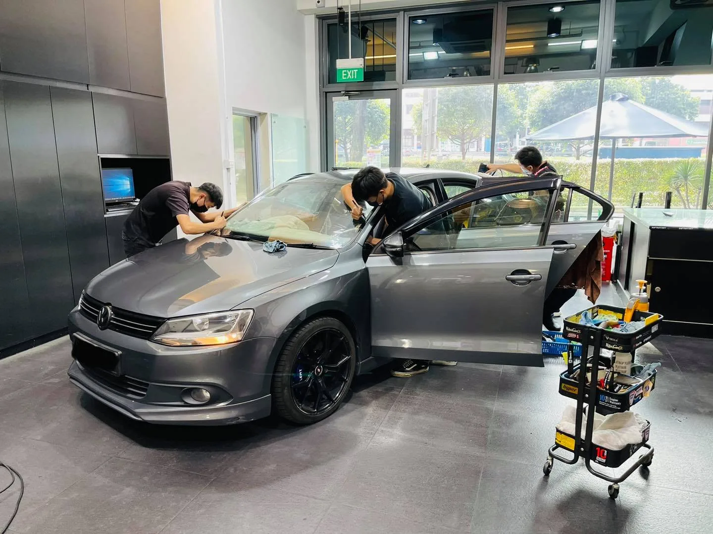 Grey VW Jetta during window film install at Infratint Singapore