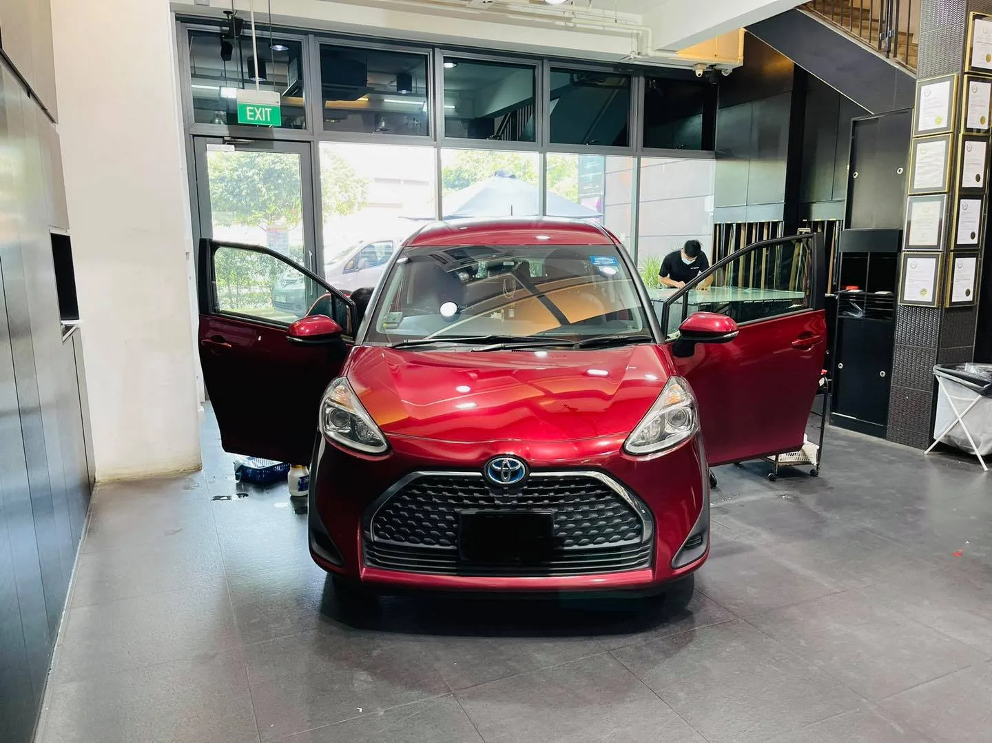 Red Toyota Sienta with doors open before tinting at Infratint Singapore