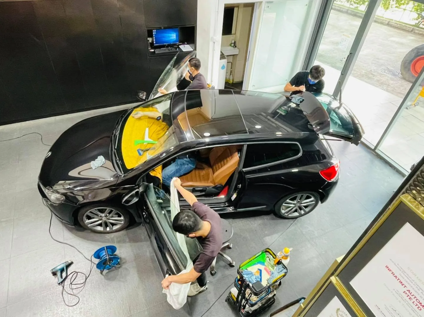 Overhead view of a black Volkswagen Scirocco being tinted at Infratint Singapore