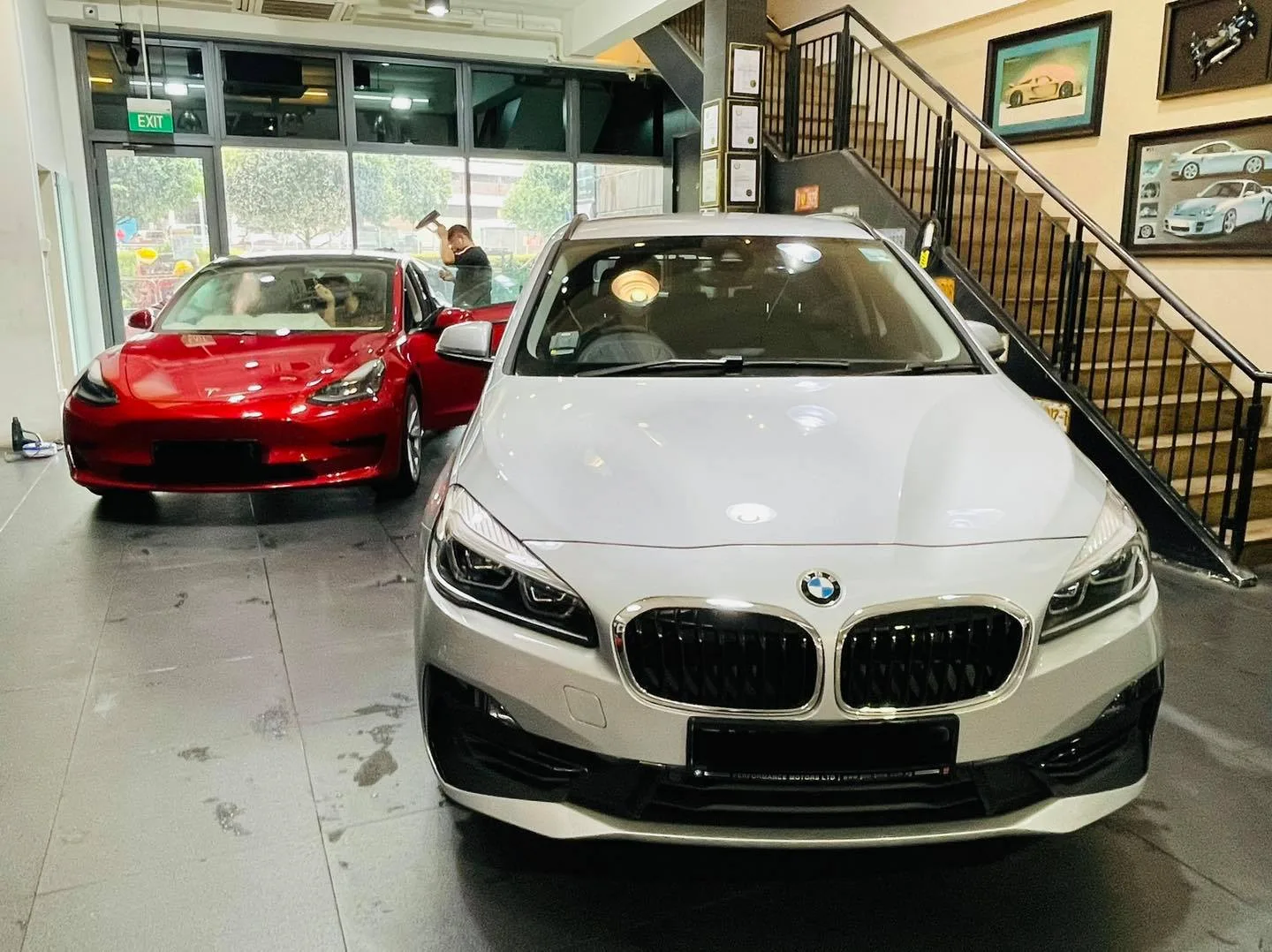 Red Tesla Model 3 and silver BMW 2 Series in the Infratint Singapore showroom
